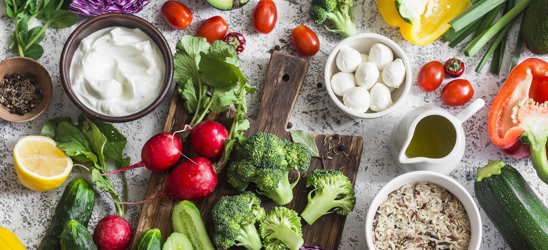 Fresh vegetables and ingredients on a rustic wooden surface.