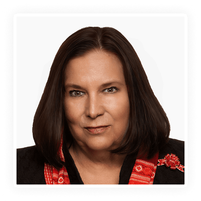Professional portrait of a woman with dark hair and a red-patterned scarf.