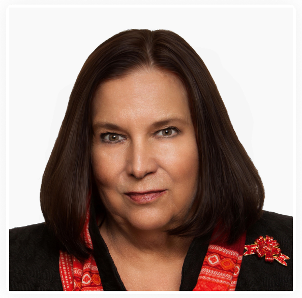 Professional headshot of a confident woman with dark hair.