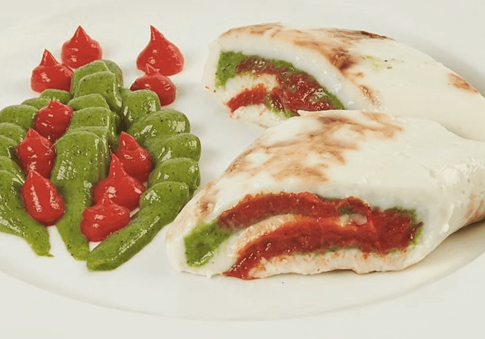 Stuffed flatbread with colorful sauces on a plate.
