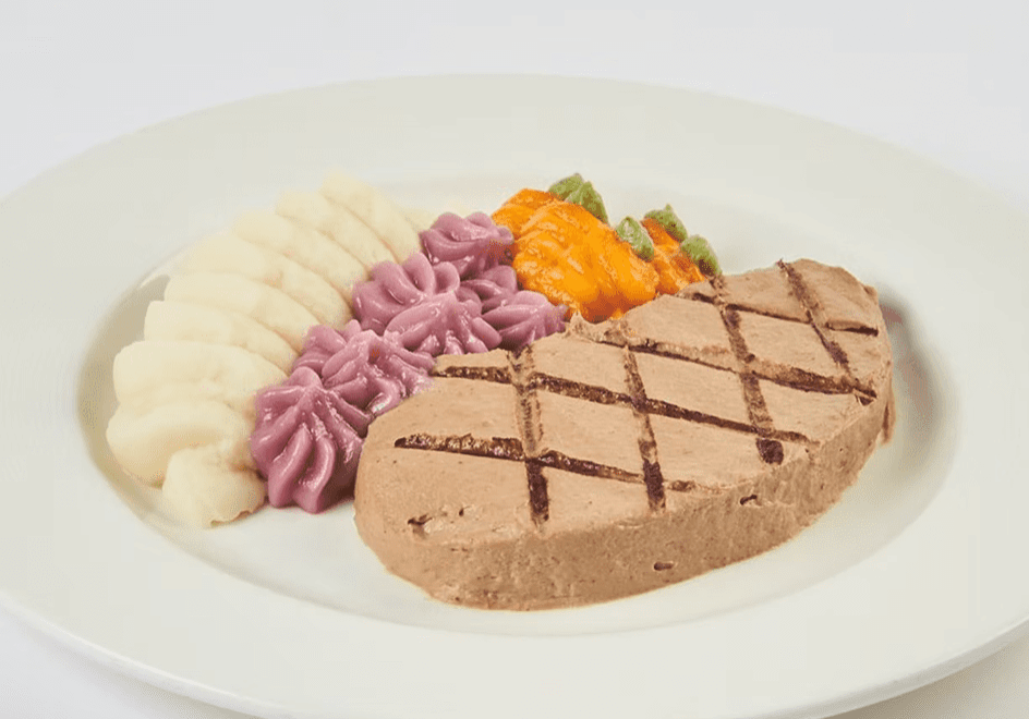 Grilled meatloaf with mashed potatoes and colorful vegetable mash.